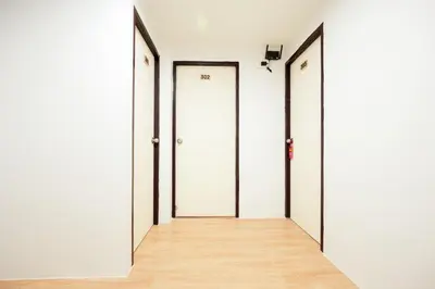 an empty corridor with three doors in a room at XX Snap Sukhumvit 1 -BTS Nana Bangkok in Makkasan