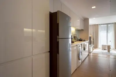 a kitchen with a refrigerator in a white kitchen at 2BR2BA BTS Thonglor Rooftop Pool Gym BBQ Low in Bangkok