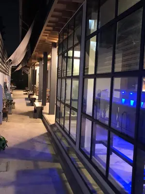 a train is seen through the windows of a building at Bluefin Guesthouse in Bangkok