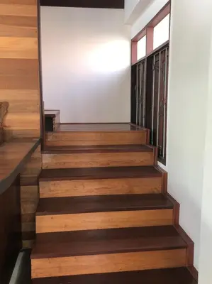 a staircase with wood treads and a window at Bluefin Guesthouse in Bangkok