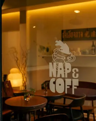 a restaurant with tables and a sign that says nap and cut at Nap Old Town in Bangkok
