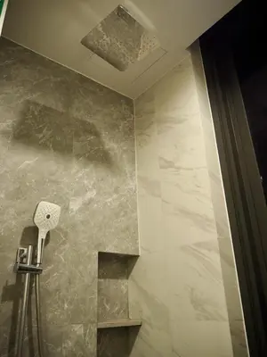 a bathroom with a stone wall and a ceiling at The Crest Park Residences Monthly Rent only #2BR Apartment at Chatuchak #MrtBts in Bangkok