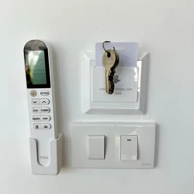 a key in an electronic device with a cell phone at XX Rest Inn Silom Bangkok in Bang Rak