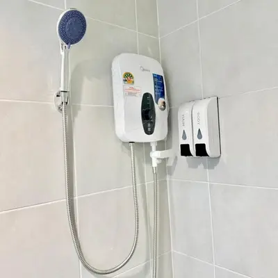 a shower in a bathroom with a blow dryer at XX Rest Inn Silom Bangkok in Bang Rak