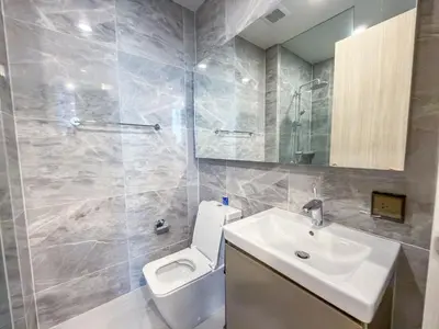 a bathroom with a toilet and a sink and a mirror at Luxury Residence in Central of Bangkok Siam Paragon Central World in Pratunam