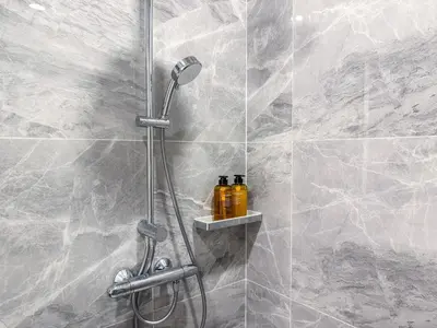 a shower with a shower head in a bathroom at Luxury Residence in Central of Bangkok Siam Paragon Central World in Pratunam