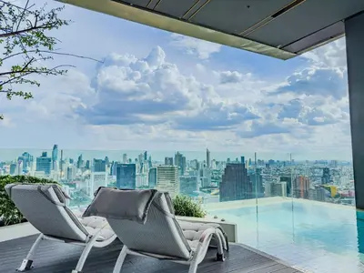 a balcony with two chairs and a view of a city at Luxury Residence in Central of Bangkok Siam Paragon Central World in Pratunam
