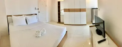 a bedroom with two beds with white shoes on it at Grandview Ladprao Hotel in Bangkok