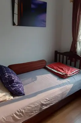 a bed with two pillows on top of it at Cosy Preuksa House 120 in Bang Yai