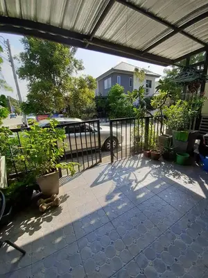 a patio with potted plants and a fence at Cosy Preuksa House 120 in Bang Yai
