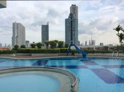 a swimming pool with a water slide in a city at BKK 2 BR apt near Sathon ICONSIAM firework view in Bangkok
