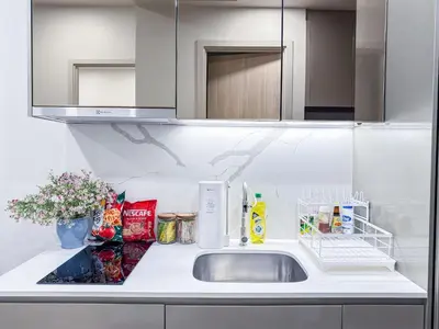 a kitchen counter with a sink and a mirror at New Residence in Central Bangkok Siam Paragon Central World in Pratunam