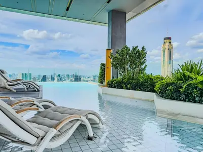a pool on the roof of a building with a chair at New Residence in Central Bangkok Siam Paragon Central World in Pratunam