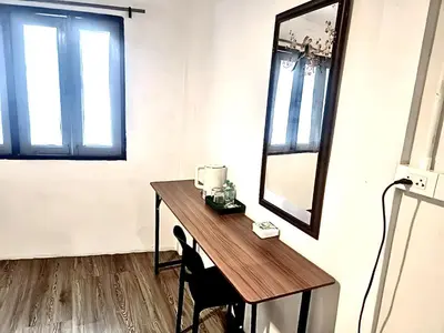 a room with a table and a mirror on a wall at xx zNap Yaowarat MRT วัดมังกร ใกล้สถานี 100 เมตร in Samphanthawong