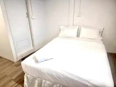 a bed with white sheets and pillows in a room at xx zNAP Yaowarat - สแนป เยาวราช MRT วัดมังกร in Samphanthawong