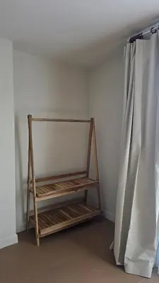 a shelf in a room with a curtain at Bangkok Duplex Silom No 6 in Bangkok