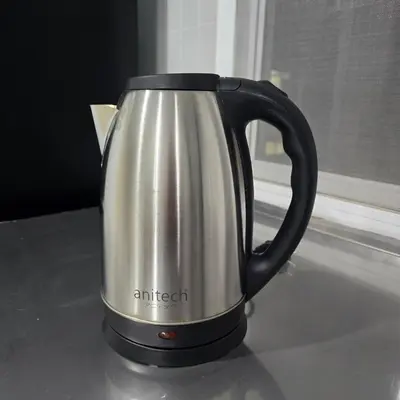 a silver and black tea kettle sitting on a counter at Bangkok Duplex Silom No 6 in Bangkok