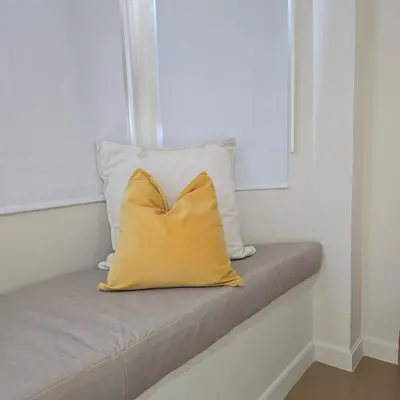 a yellow pillow sitting on top of a couch at Bangkok Duplex Silom No 6 in Bangkok