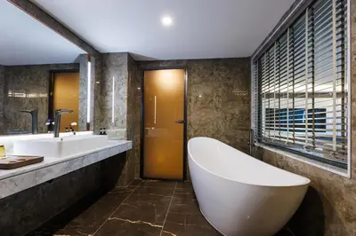 a bathroom with a large tub and a sink at Maritztel Bangkok Hotel in Ban Bang Toei (1)