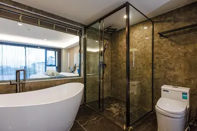 a bathroom with a tub and a shower and a toilet at Maritztel Bangkok Hotel in Ban Bang Toei (1)