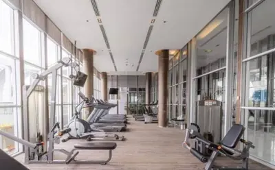 a gym with a row of exercise bikes in a room at The Onnut Nest 1BR Sofa Bed Onnut BTS 50m in Bangkok
