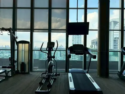a gym with two exercise bikes in front of a window at The Onnut Nest 1BR Sofa Bed Onnut BTS 50m in Bangkok