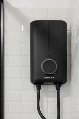 a black phone is attached to a wall at Luxe apartments in Pratunam