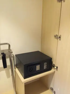 a microwave sitting on a shelf next to a door at The Bazaar Hotel Bangkok - MRT Lat Phrao Ratchadapisek in Bangkok