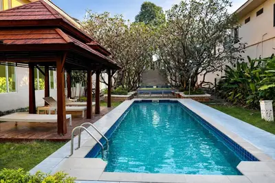 a swimming pool in a yard with a gazebo at Palette Bangkok Natural Resort and Spa in Bangkok