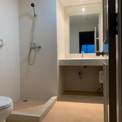 a bathroom with a shower and a sink and a toilet at City Living condo at BKK in Bangkok