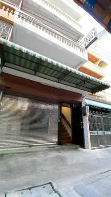 a building with an open garage door with awning at xx GO INN Grand Palace - โก อินน์ พระบรมมหาราชวัง เจริญกรุง 1 in Bangkok