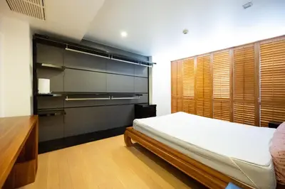 a bedroom with a bed and a large window at Beautiful 1 bed with huge Lumpini park view in Bangkok
