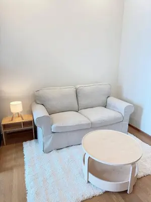 a living room with a couch and a table at Brand New CONDO near Siam Paragon in Pratunam