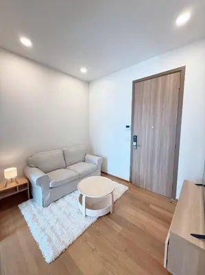 a living room with a couch and a table at Brand New CONDO near Siam Paragon in Pratunam