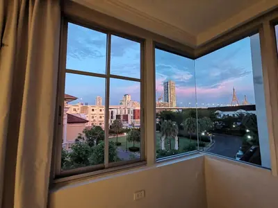 a room with a window with a view of a city at Spacious 3 Ensuite Bedrooms Townhouse in Rama 3, Bangkok in Bangkok