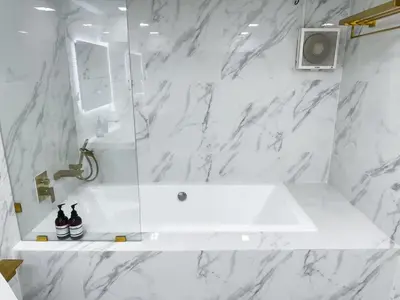 a white bathroom with a sink and a shower at Huai Khwang Townhome in Ban Na Song