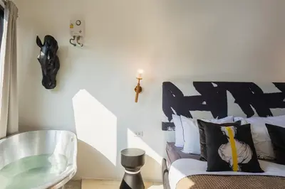 a bedroom with a bed and a glass table at Studio Kunst in Bangkok