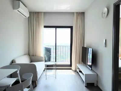 a small living room with a couch and a window at Apartment in Thon Buri 0 meter From BTS station in Bang Khun Thian