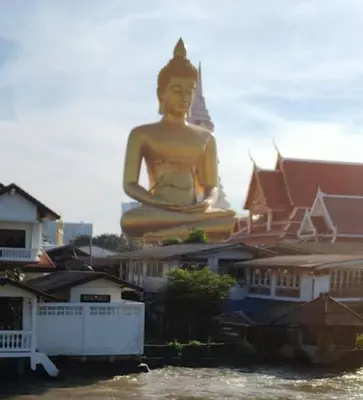 a large statue in front of a bunch of buildings at Apartment in Thon Buri 0 meter From BTS station in Bang Khun Thian