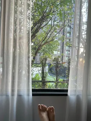 a pair of feet sitting on a window sill at 2 Bed 2 Bath Condo Steps to BTS&MRT in Bangkok