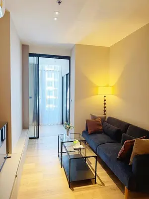 a living room with a couch and a table at Thonglor Ekkamai 10 mins Sky Pool 1BR in Bangkok