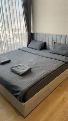 a bed with two towels on it in a bedroom at Thonglor Ekkamai 10 mins Sky Pool 1BR in Bangkok