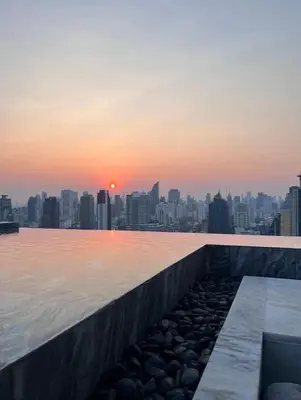 a view of a city skyline from a swimming pool at Thonglor Ekkamai 10 mins Sky Pool 1BR in Bangkok