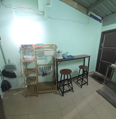 a small table and two stools in a room at 103 Lovely AC apartment with private kitchen in Bangkok