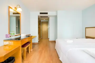 a bedroom with a desk and a bed and a mirror at xx Wish Inn Chidlom - Ratchadamri 2 in Pratunam