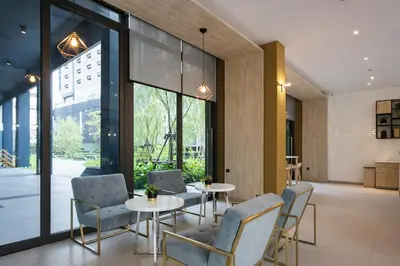 a dining room with a table and chairs and glass doors at 2BR Modern Condo Office Room Sofa Bed Pool Gym in Bangkok