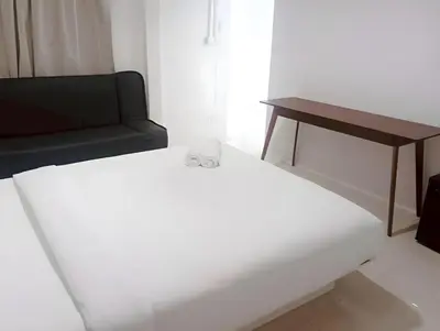 a living room with a couch and a table at XX Mitr Inn Sukhumvit Soi 2 - มิตร อินน์ สุขุมวิท ซอย 2 BTS Nana in Bang Kapi