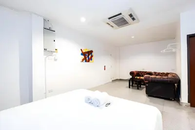 a room with two beds and a couch in it at XX Mitr Inn Sukhumvit Soi 2 - มิตร อินน์ สุขุมวิท ซอย 2 BTS Nana in Bang Kapi
