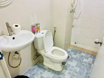 a bathroom with a toilet and a sink at BKK Rama3 Guest House in Bangkok