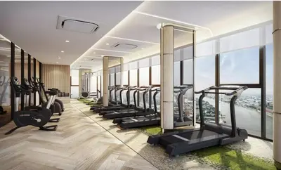 a gym with a row of treadmills and ellipticals at 2 Bunk bed Lady Room, MRT Bang Pho in Bangkok